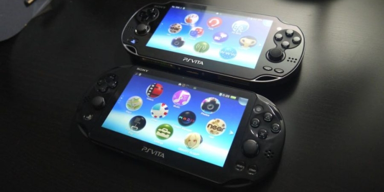 PS Vita are laid down on a table.